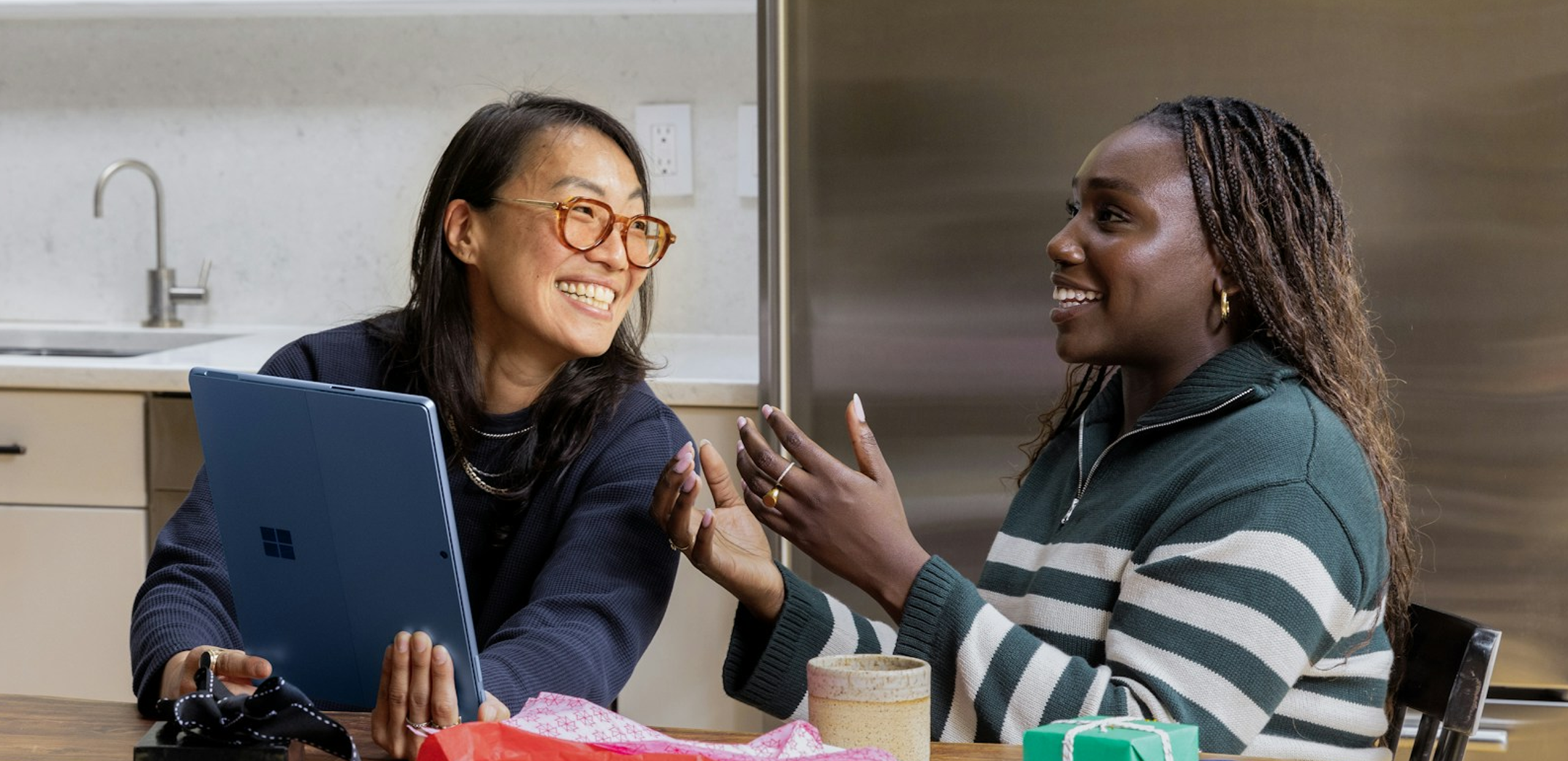Two ladies around a laptop